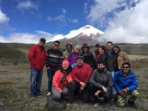 Group of hikers posing with Pichincha volcano in the background
