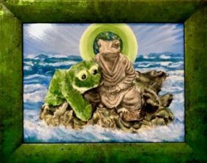 Green frame surrounding fanciful painting of green frog clinging to frog statue in the sea