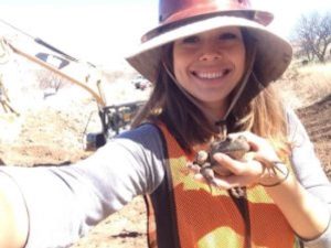 Educator Kathlyn Franco Osagie holds a frog in the sunlight